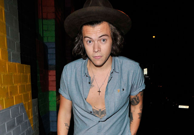 Harry Styles flashes his chest and demonstrates some superb hat-wearing