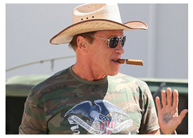 Arnold Schwarzenegger wears a cowboy hat, puffs a cigar and drives a DOORLESS Hummer in Beverly Hills